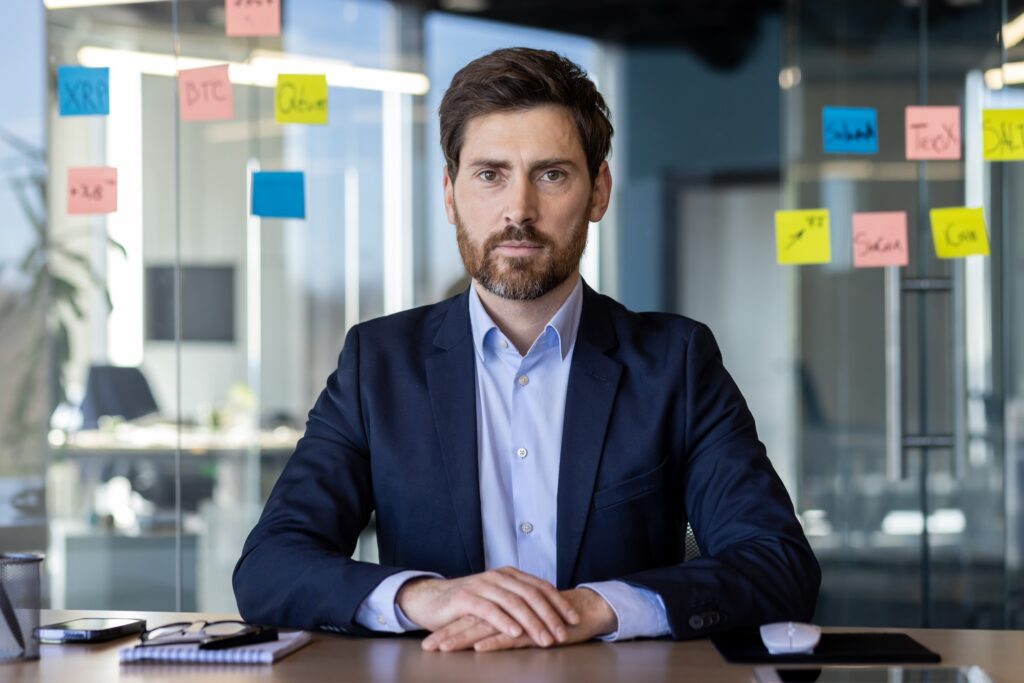 Confident businessman in office with strategic notes