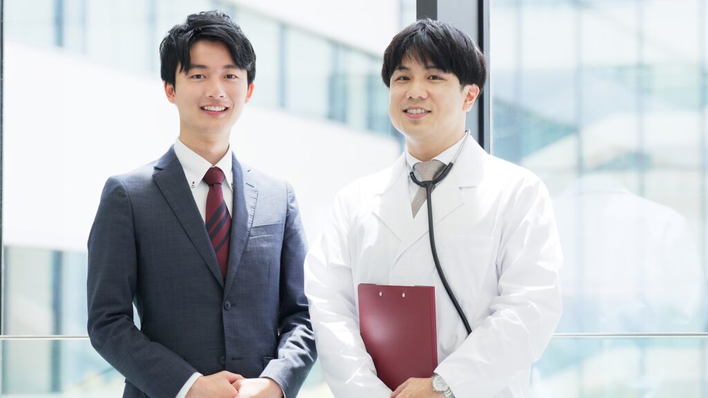 Smiling doctor and sales man standing